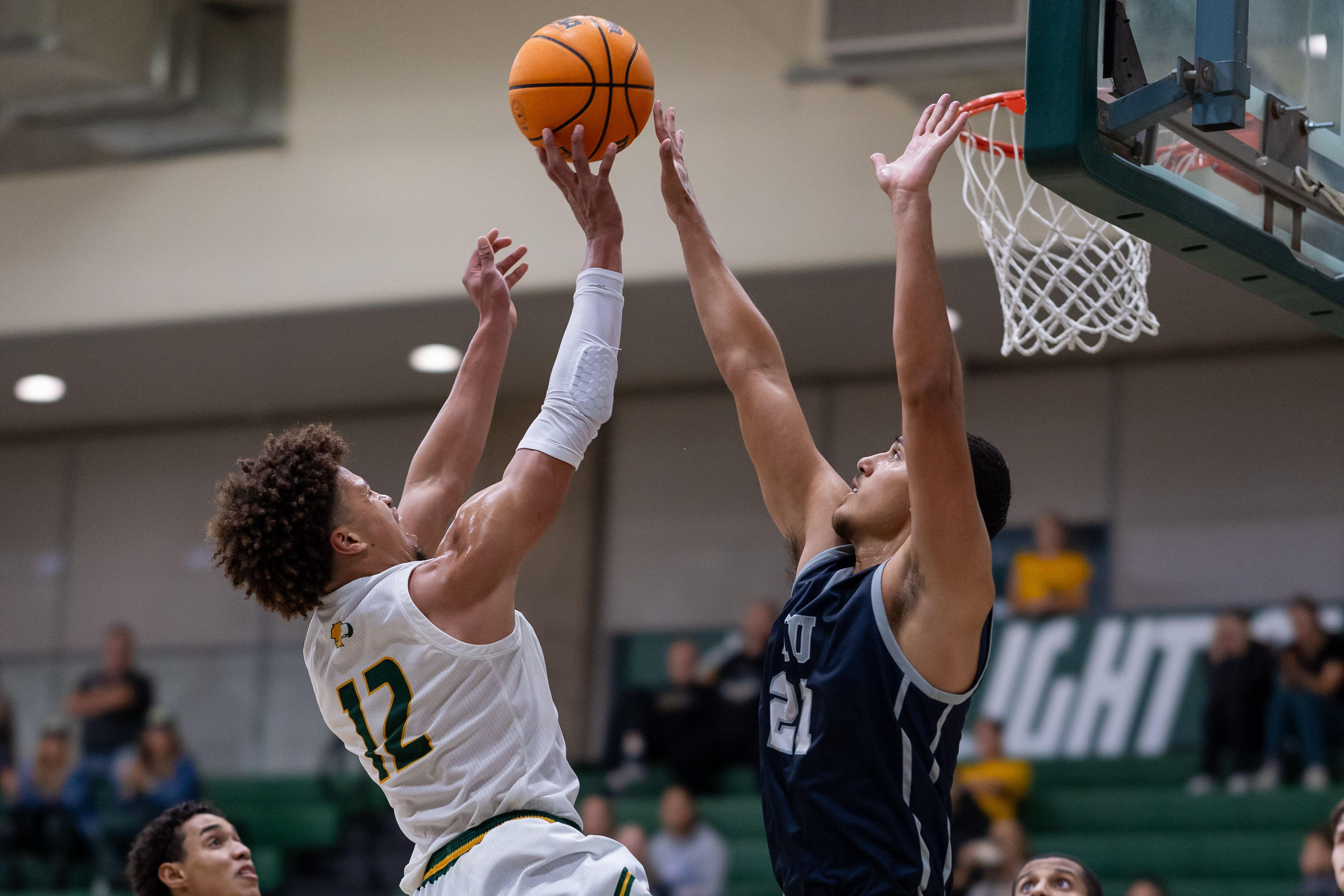  #12, Jayce Catchings goes up to the basket against HIU.